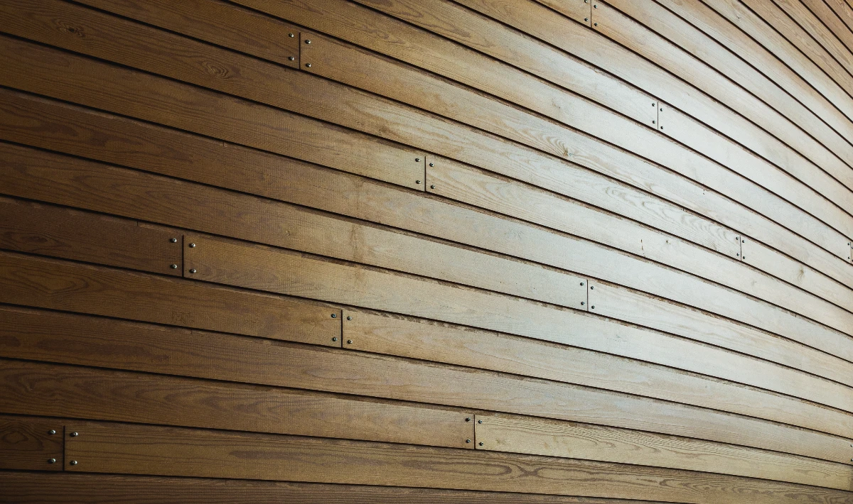 Horizontal wooden slat wall design widening compact office spaces