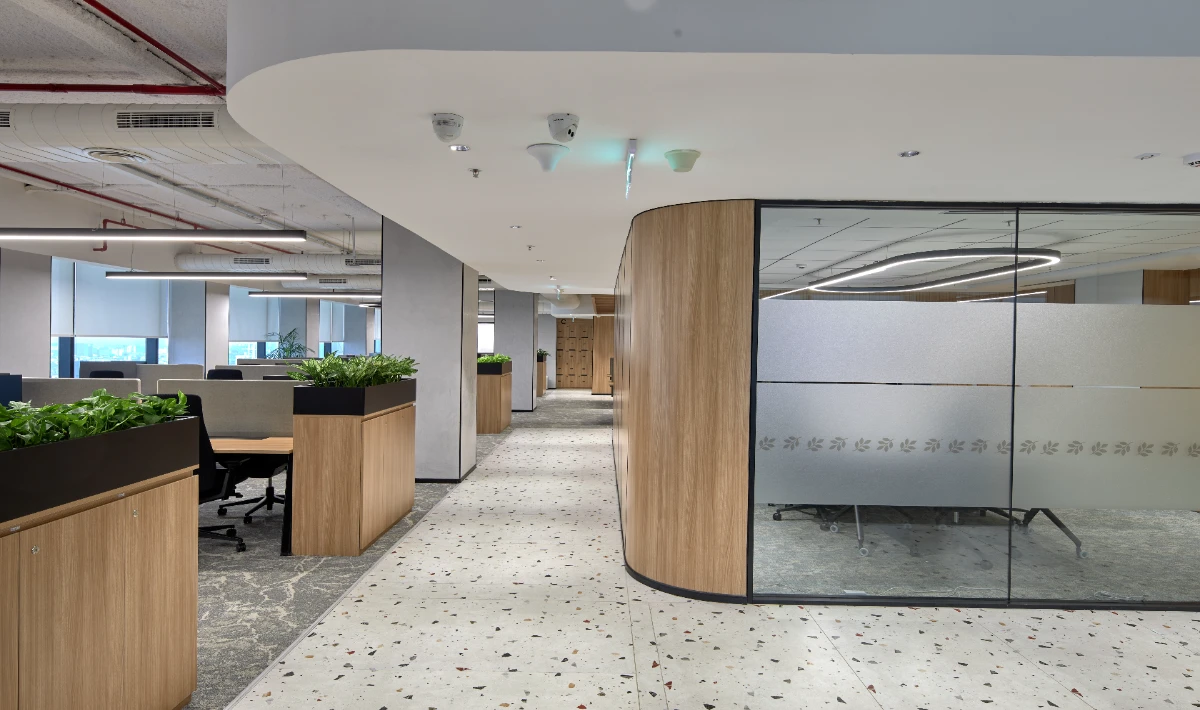 Mirror accent wall reflecting light in a compact workspace