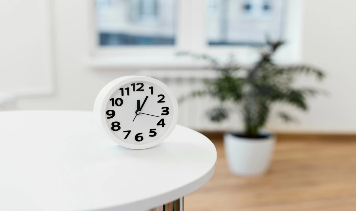 Small desk clock adding balance to the workspace and supporting time