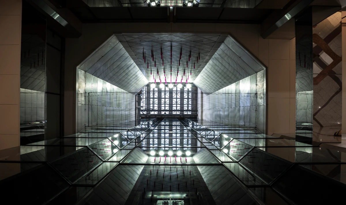 Office ceiling design with reflective metallic panels adding height and light.