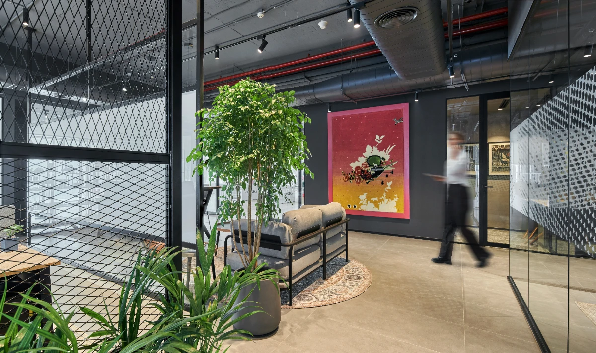 Office interior with plants, natural materials, and green design