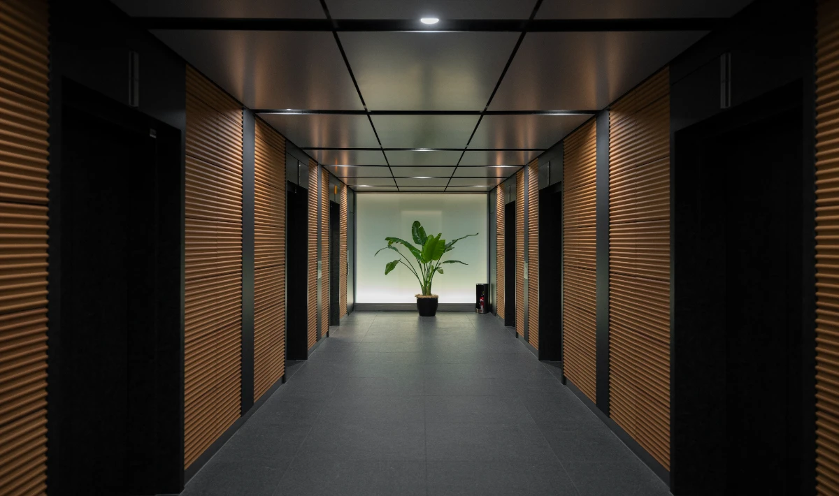 Dark toned office wall tiles creating contrast in selected zones up