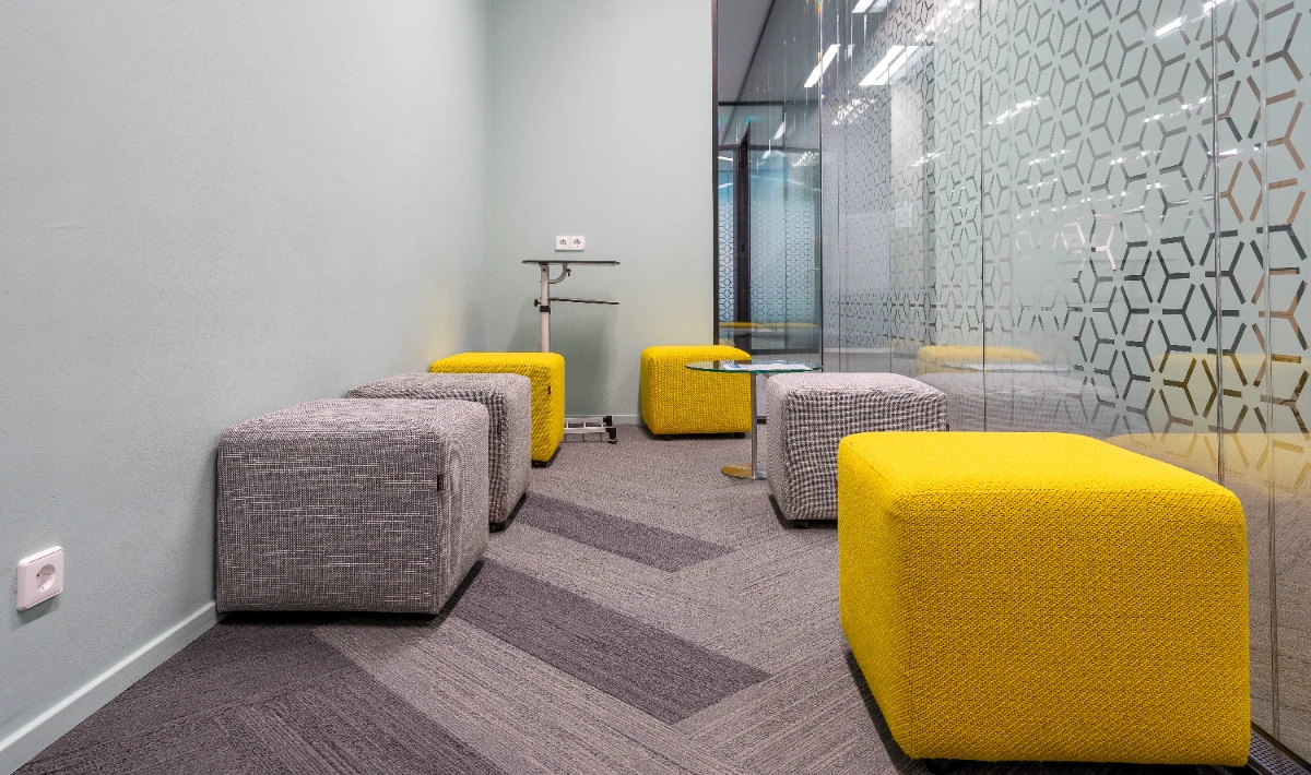 Soft seating corners integrated into modern office layout design