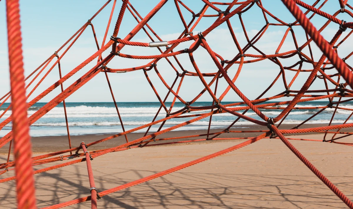 Rope or cable partitions creating visual zones without solid walls