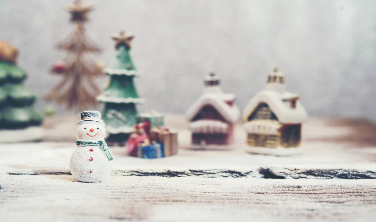 Small Christmas village setup placed on office reception desks for warmth