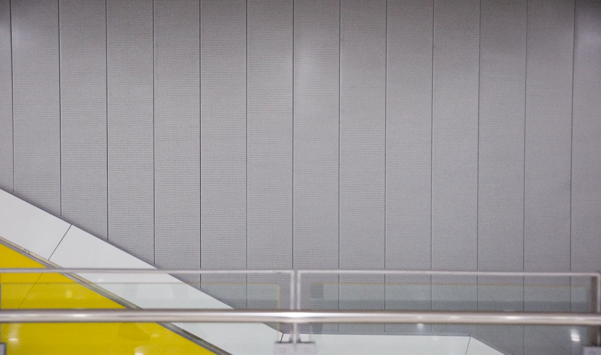 Vertical office wall tiles creating height illusion in a small office