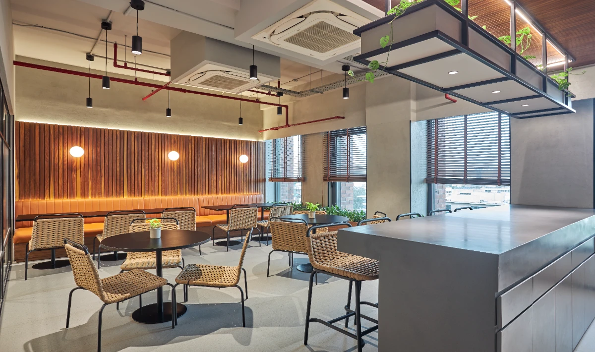 Compact office break corner with table and seating area.