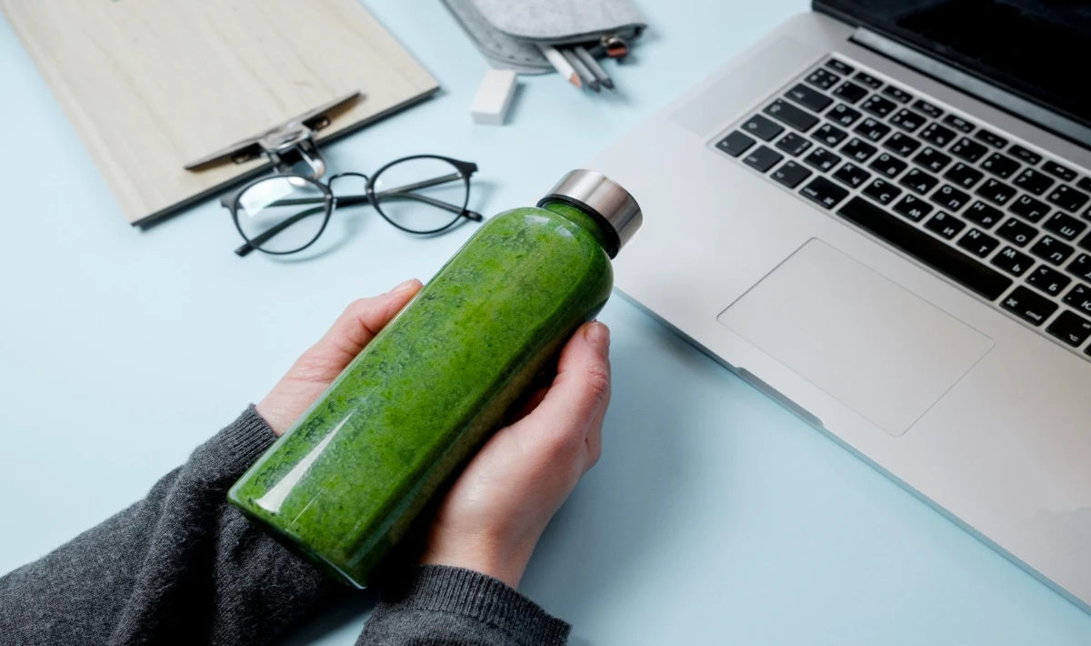 Hydration bottle on a work desk, adding colour and supporting wellness