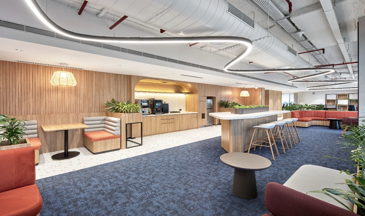 Open ceiling industrial office interior with exposed ducts and lighting