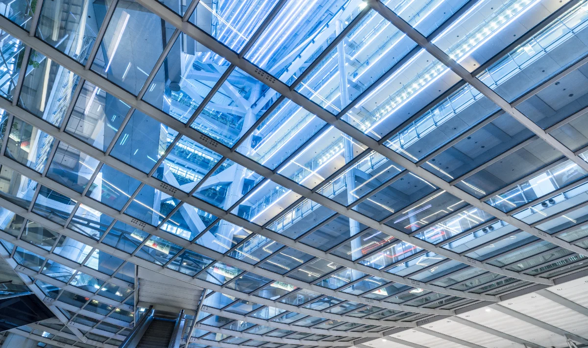 Glass false ceiling design for a bright and collaborative workspace.